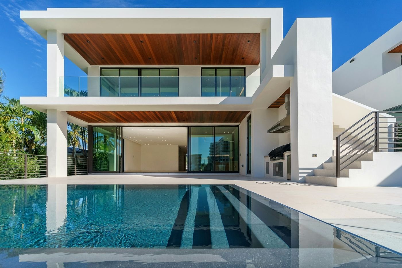Two-storey home with timber soffits and a pool