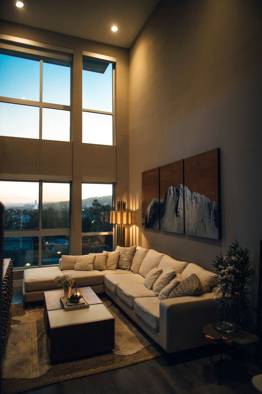 Double-height living room with a timber staircase
